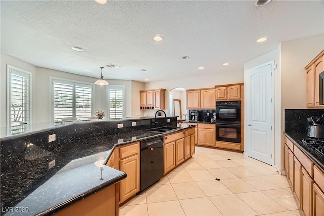 kitchen with a sink, black appliances, arched walkways, recessed lighting, and decorative backsplash