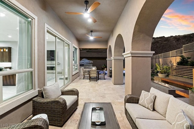 38 Costa Tropical Dr, Henderson, NV 89011 - patio terrace at dusk featuring an outdoor hangout area, fence, and ceiling fan