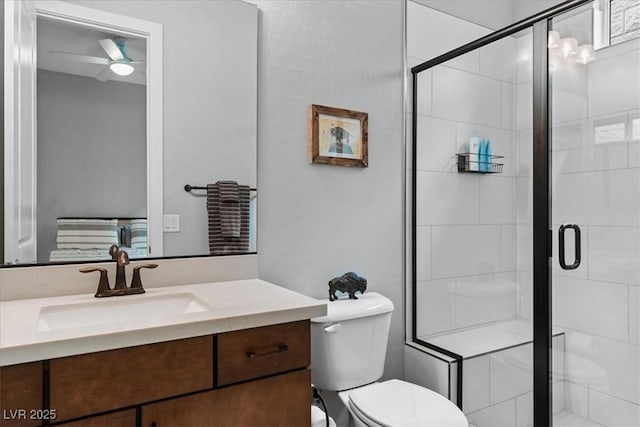 38 Costa Tropical Dr, Henderson, NV 89011 - bathroom featuring a shower stall, vanity, toilet, and a ceiling fan