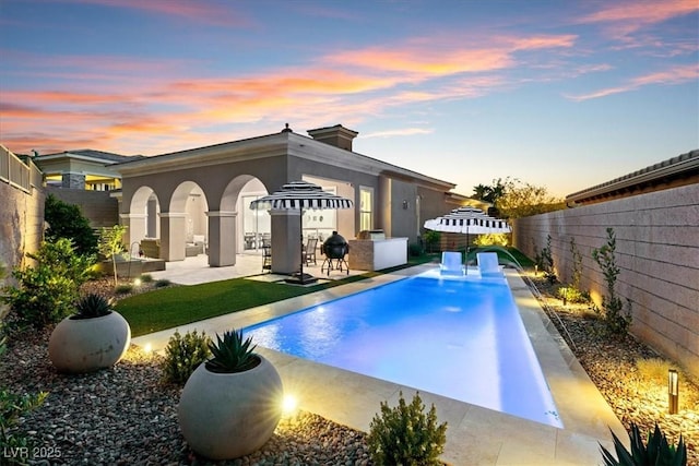 38 Costa Tropical Dr, Henderson, NV 89011 - rear view of property with a patio area, a fenced backyard, and stucco siding