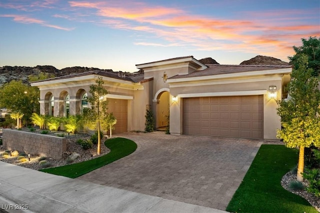 38 Costa Tropical Dr, Henderson, NV 89011 - view of front of home with a garage, decorative driveway, and stucco siding