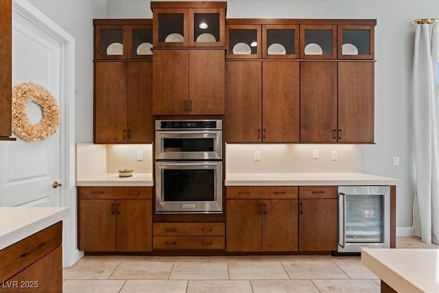 38 Costa Tropical Dr, Henderson, NV 89011 - kitchen featuring wine cooler, stainless steel double oven, light countertops, glass insert cabinets, and light tile patterned flooring