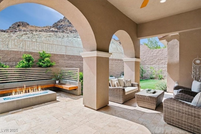 38 Costa Tropical Dr, Henderson, NV 89011 - view of patio with an outdoor hangout area, a fenced backyard, a ceiling fan, and a mountain view