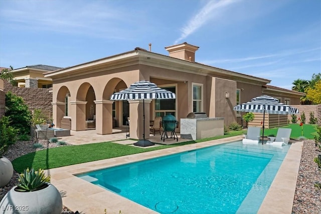 38 Costa Tropical Dr, Henderson, NV 89011 - back of house with a patio area, stucco siding, and a chimney