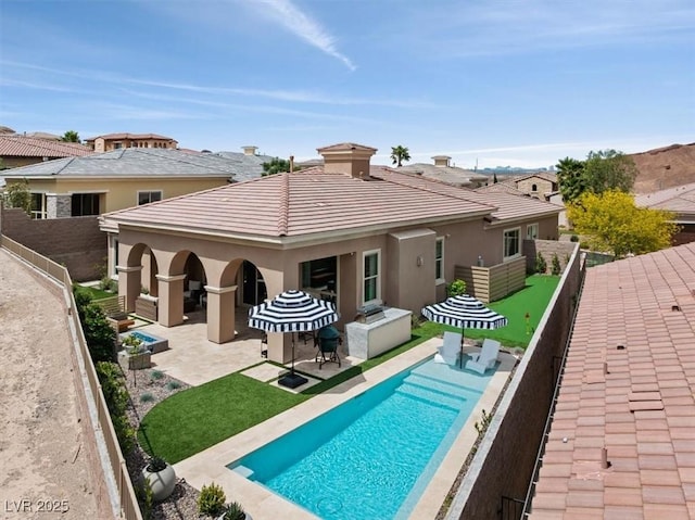 38 Costa Tropical Dr, Henderson, NV 89011 - rear view of house with a patio, stucco siding, a fenced backyard, and a tile roof