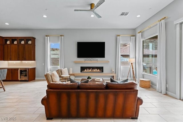 38 Costa Tropical Dr, Henderson, NV 89011 - living area featuring a lit fireplace, recessed lighting, healthy amount of natural light, light tile patterned flooring, and a ceiling fan