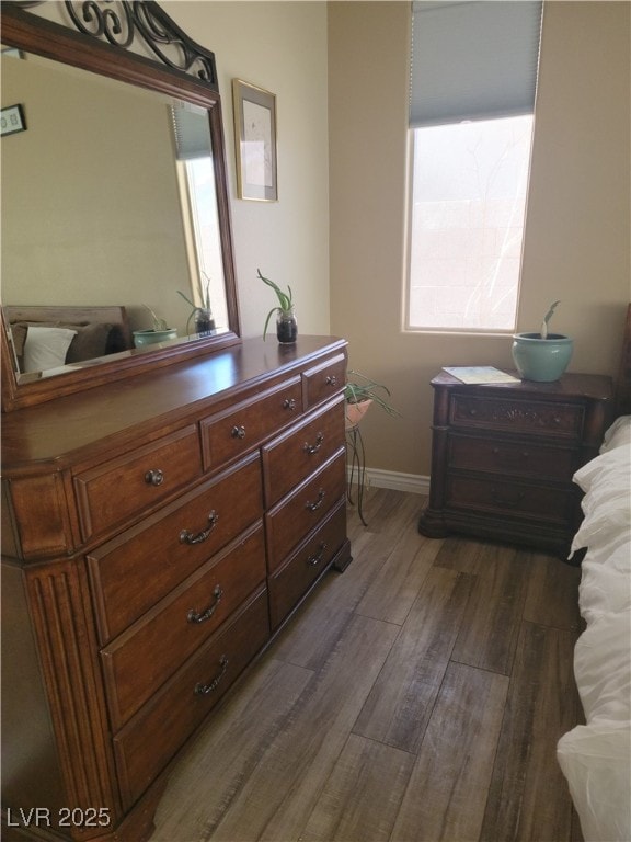 bedroom with dark wood-type flooring, multiple windows, and baseboards