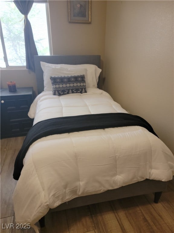 bedroom with wood finished floors