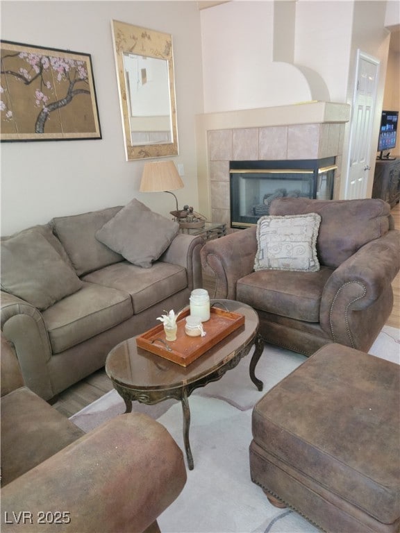 living area featuring a fireplace and carpet