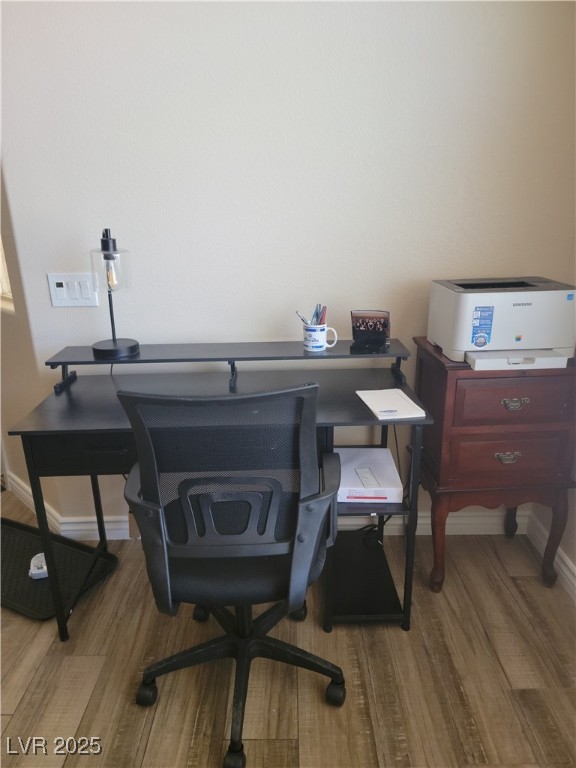 office space with wood finished floors and baseboards