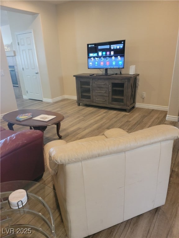 living room featuring wood finished floors and baseboards