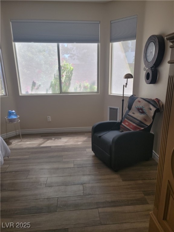 living area featuring wood finished floors and baseboards