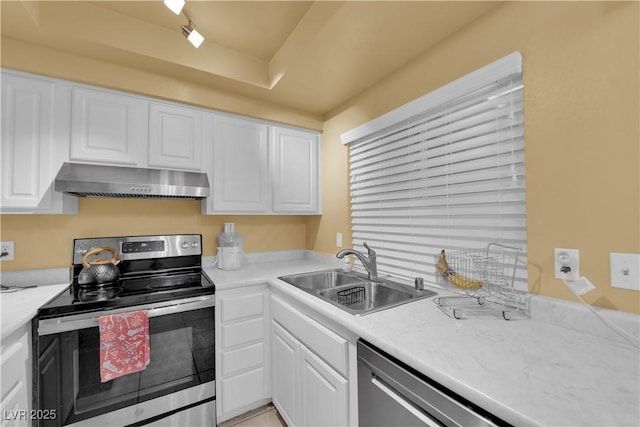 4770 Topaz St Unit 108, Las Vegas, NV 89121 - kitchen with stainless steel appliances, a sink, exhaust hood, and white cabinets