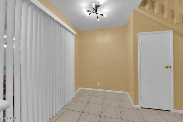 4770 Topaz St Unit 108, Las Vegas, NV 89121 - spare room with light tile patterned floors, baseboards, and a chandelier
