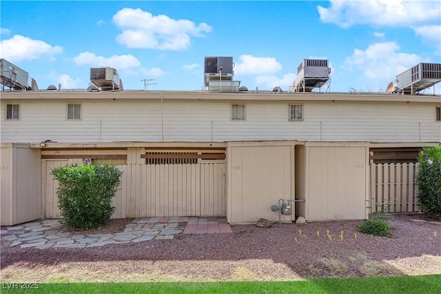 4770 Topaz St Unit 108, Las Vegas, NV 89121 - rear view of house featuring central air condition unit and fence