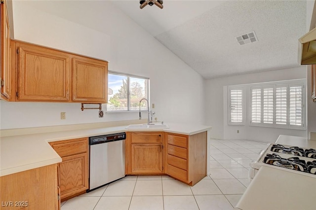 6432 Jean Lee Dr, Las Vegas, NV 89108 - kitchen with stainless steel dishwasher, a sink, a peninsula, light tile patterned flooring, and light countertops