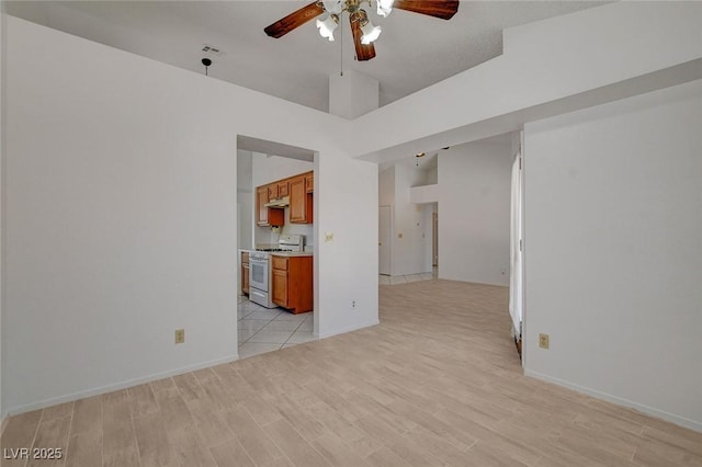 6432 Jean Lee Dr, Las Vegas, NV 89108 - unfurnished living room featuring ceiling fan, light wood-style flooring, and baseboards