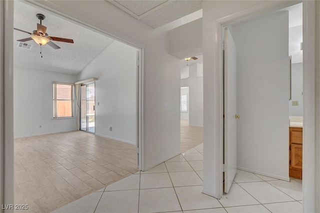 6432 Jean Lee Dr, Las Vegas, NV 89108 - spare room featuring ceiling fan, a textured ceiling, baseboards, and light tile patterned flooring