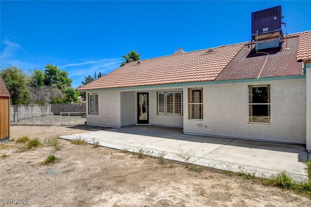6432 Jean Lee Dr, Las Vegas, NV 89108 - back of house featuring a tile roof, stucco siding, a patio, and central AC