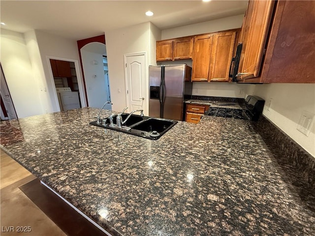 5019 Quiet Falls Ct, Las Vegas, NV 89141 - kitchen featuring black appliances, separate washer and dryer, brown cabinetry, a peninsula, and recessed lighting