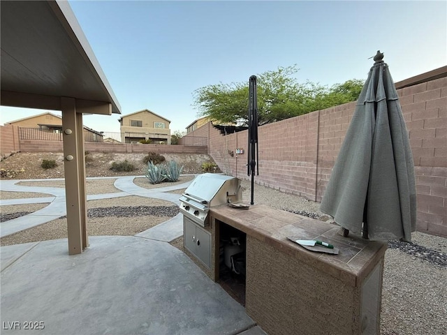 5019 Quiet Falls Ct, Las Vegas, NV 89141 - fenced backyard with an outdoor kitchen and a patio area
