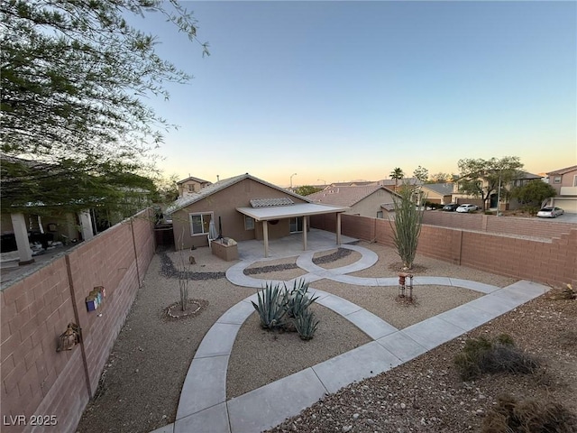 5019 Quiet Falls Ct, Las Vegas, NV 89141 - patio terrace at dusk with a patio area and a fenced backyard