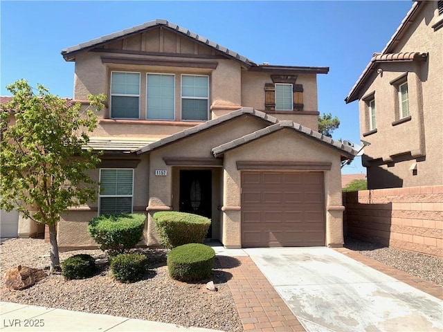 view of front of house featuring stucco siding, fence, driveway, and a tile roof
