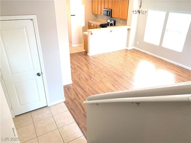 living area with baseboards and light tile patterned floors