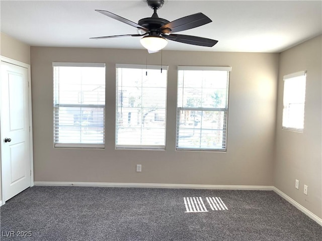 unfurnished room featuring carpet flooring, a ceiling fan, and baseboards
