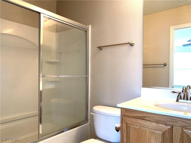 full bathroom with vanity, toilet, and enclosed tub / shower combo