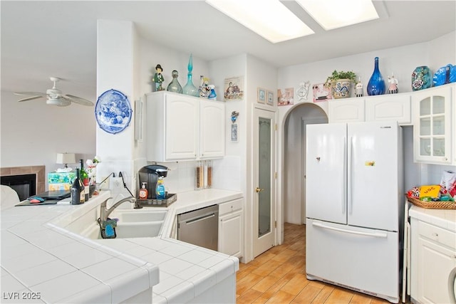 1223 Golf Club Dr, Laughlin, NV 89029 - kitchen with freestanding refrigerator, dishwasher, tile counters, and a sink