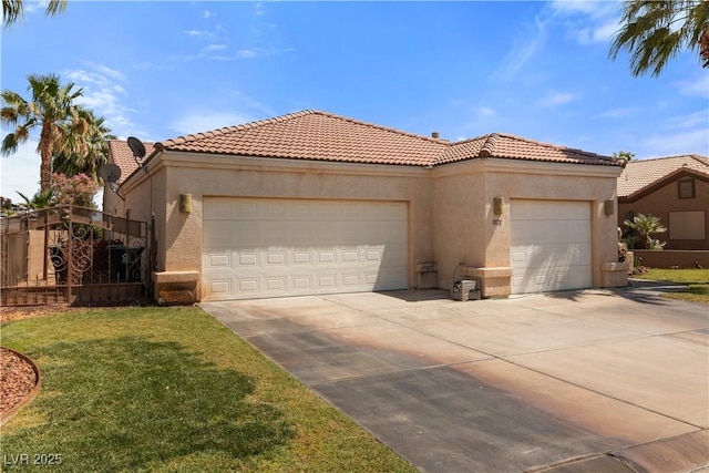 1223 Golf Club Dr, Laughlin, NV 89029 - mediterranean / spanish home featuring a garage, concrete driveway, stucco siding, and a tile roof