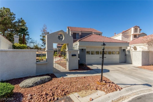 view of front of home featuring a gate, a tiled roof, a garage, a fenced front yard, and stucco siding