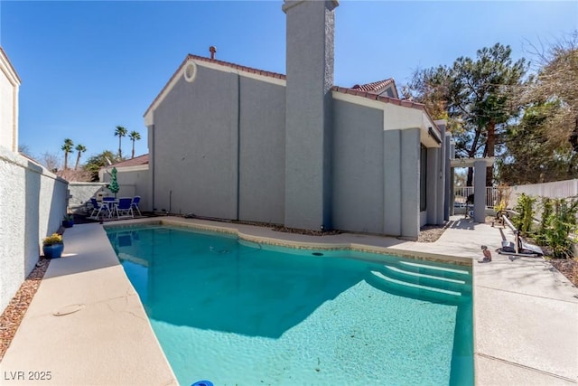 view of swimming pool featuring a fenced backyard and a patio area