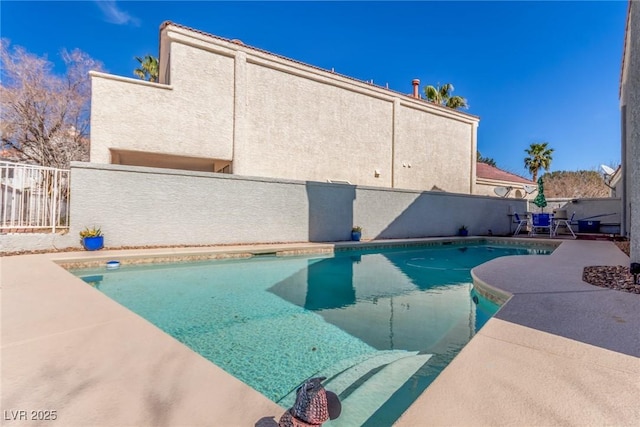 view of pool featuring fence and a patio