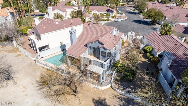 aerial perspective of suburban area featuring a pool