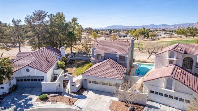 aerial view of a pool area and mountains