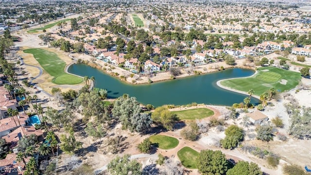 view of property location with a nearby body of water, a golf course, and nearby suburban area