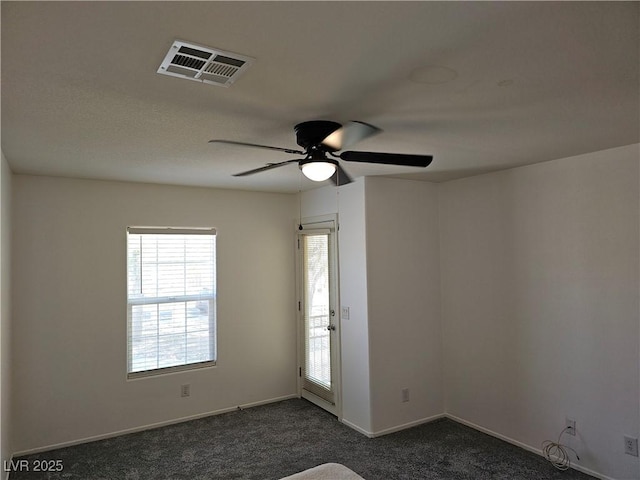 7461 Enviable Ct, Las Vegas, NV 89149 - unfurnished room featuring dark colored carpet, plenty of natural light, ceiling fan, and baseboards
