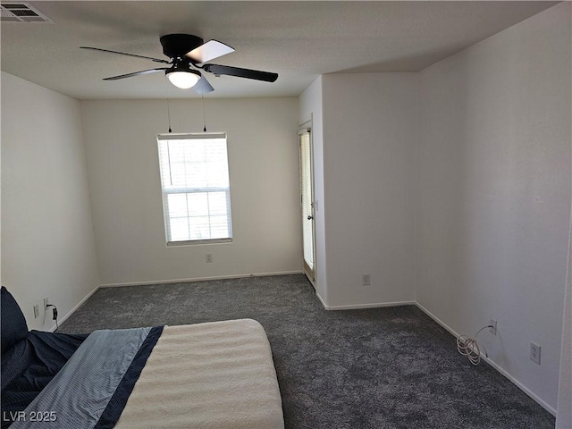 7461 Enviable Ct, Las Vegas, NV 89149 - bedroom with dark colored carpet, baseboards, and ceiling fan