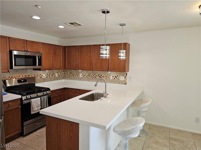 7461 Enviable Ct, Las Vegas, NV 89149 - kitchen featuring stainless steel appliances, a sink, a breakfast bar, backsplash, and recessed lighting