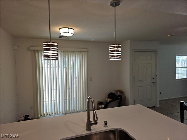 7461 Enviable Ct, Las Vegas, NV 89149 - kitchen featuring a sink, tile patterned floors, hanging light fixtures, and a chandelier