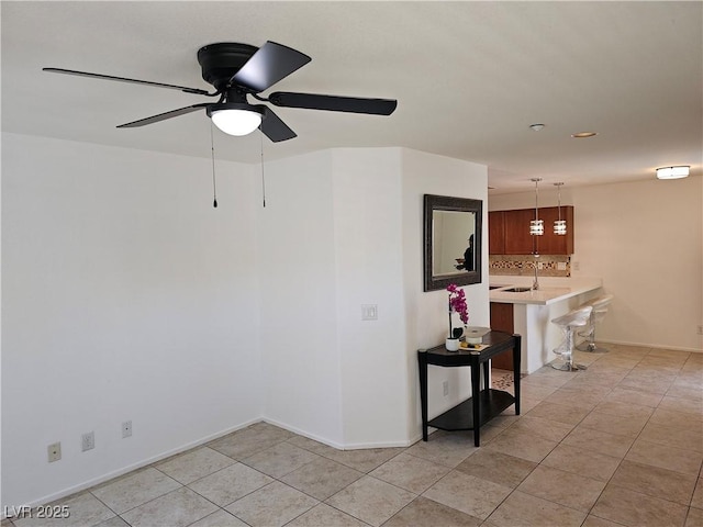7461 Enviable Ct, Las Vegas, NV 89149 - unfurnished room with light tile patterned flooring, ceiling fan, baseboards, and a sink