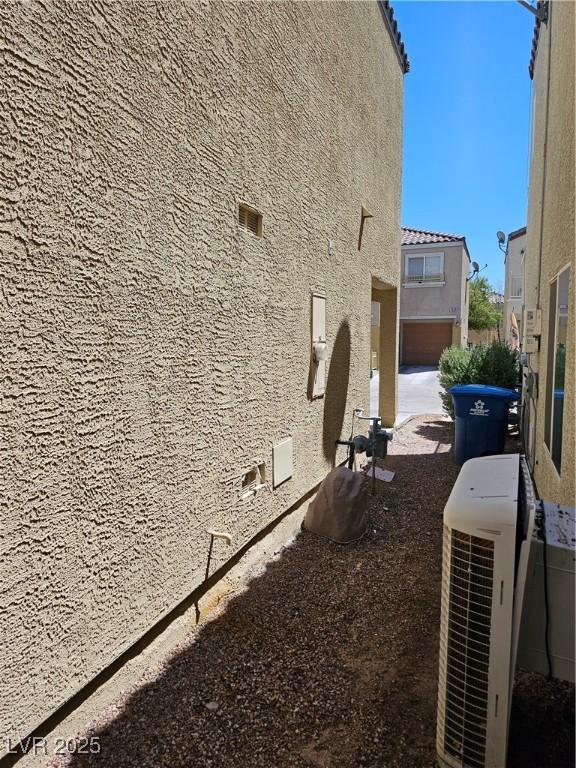 7461 Enviable Ct, Las Vegas, NV 89149 - view of property exterior with stucco siding and a cooling unit