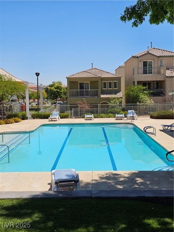 7461 Enviable Ct, Las Vegas, NV 89149 - community pool with fence, a grill, and a patio
