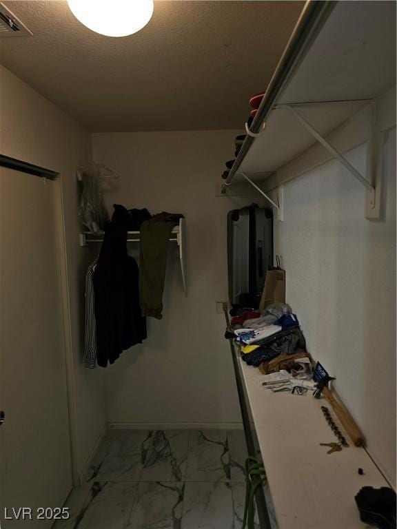 7461 Enviable Ct, Las Vegas, NV 89149 - walk in closet with light marble finish floors