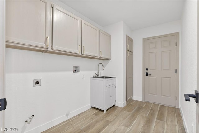 laundry area featuring hookup for a gas dryer, washer hookup, light wood-style flooring, hookup for an electric dryer, and baseboards