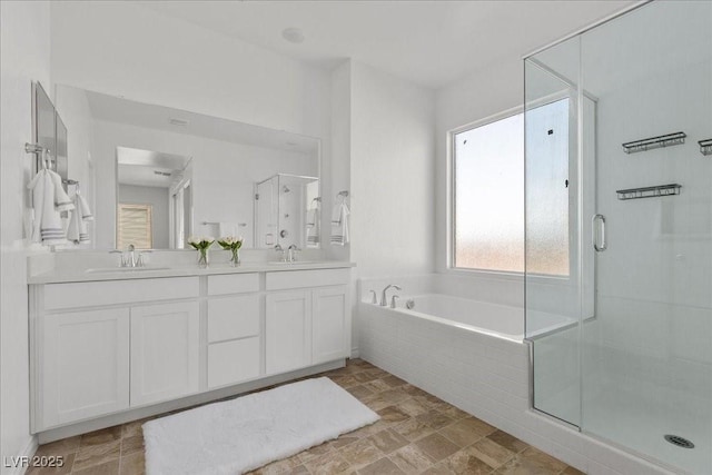 6854 Chargehand Ave, Las Vegas, NV 89156 - full bath with a garden tub, double vanity, a shower stall, and stone finish flooring