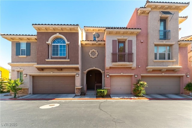9986 Sand Key St, Las Vegas, NV 89178 - view of front of home with an attached garage, stucco siding, a balcony, and a tile roof