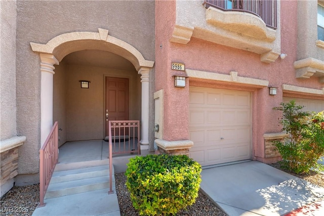 9986 Sand Key St, Las Vegas, NV 89178 - property entrance featuring stucco siding, an attached garage, and concrete driveway